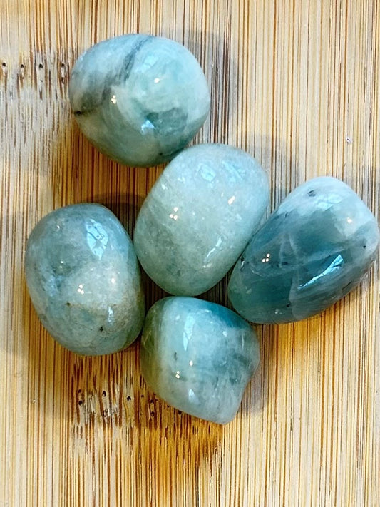 Natural Aquamarine crystal displaying soft ocean-blue tones with polished finish.