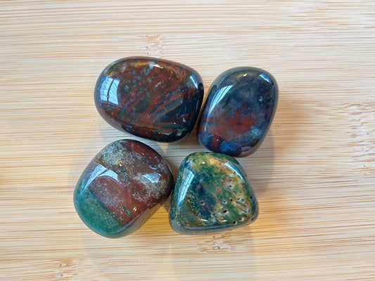 Natural African Bloodstone crystal displaying deep green tones with earthy red and golden inclusions.